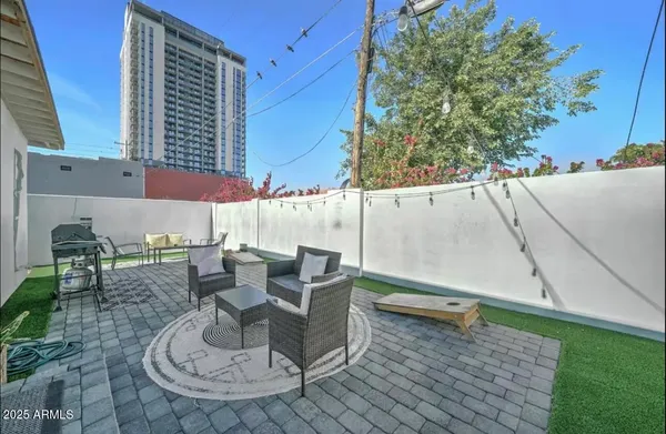 a view of a patio with table and chairs and potted plants