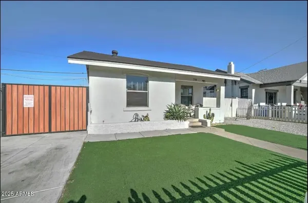 a front view of a house with garden and patio