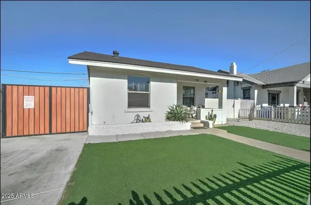 a front view of a house with garden and patio