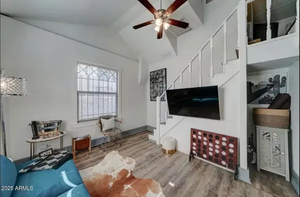 a living room with furniture and a flat screen tv