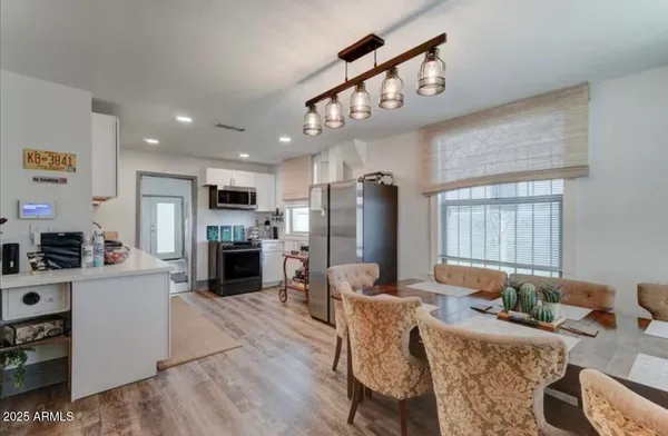 a living room with furniture a fireplace and a open kitchen view