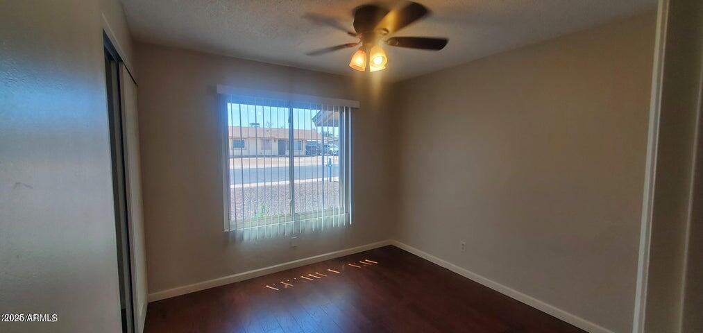 824 West Fordham Drive Tempe, AZ 85283 - Photo 14 of 20 a view of an empty room with wooden floor and a window