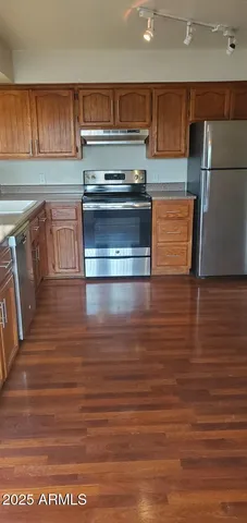 a kitchen with granite countertop a stove and a sink