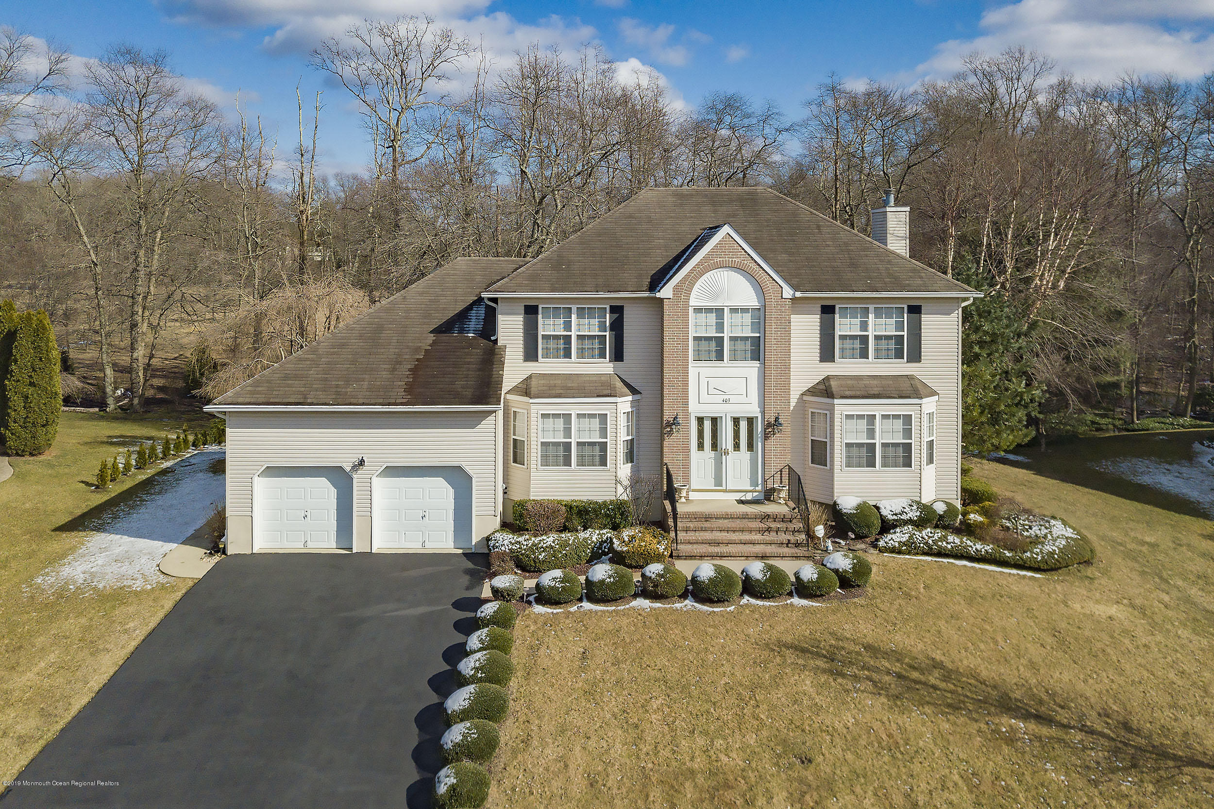 403 Meadowood Road Jackson, NJ 08527 - Photo 2 of 46 a front view of a house with a yard