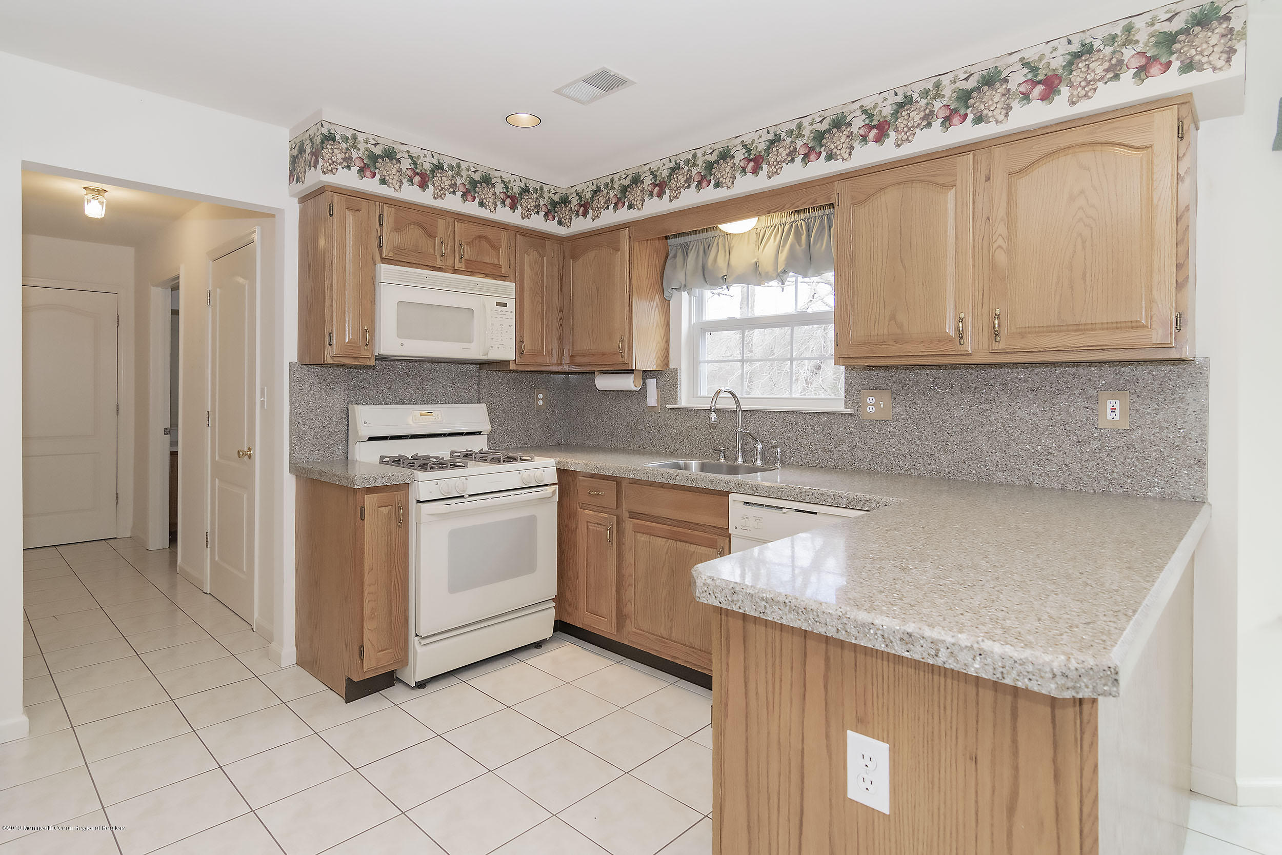 403 Meadowood Road Jackson, NJ 08527 - Photo 11 of 46 a kitchen with granite countertop white cabinets and white appliances
