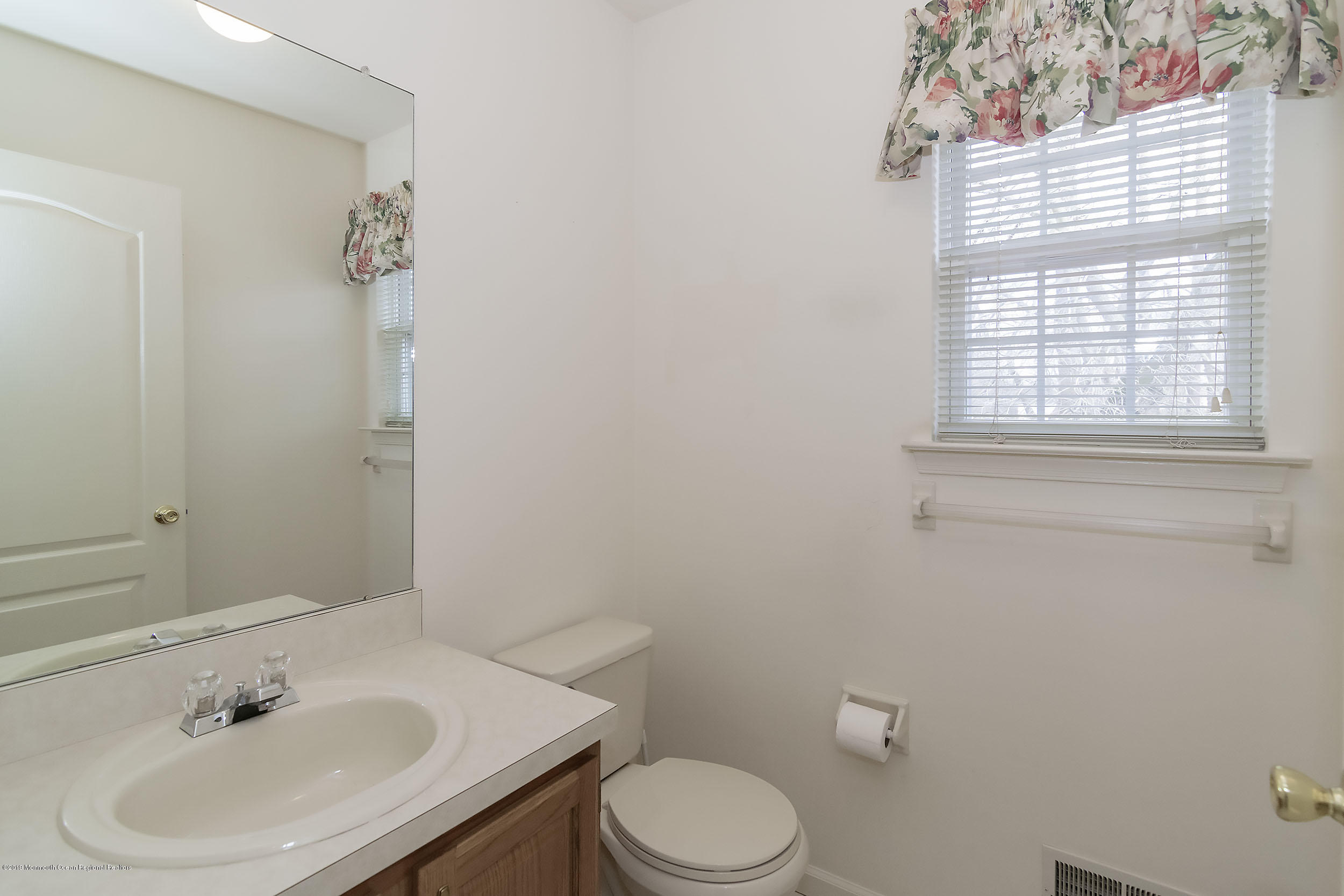 403 Meadowood Road Jackson, NJ 08527 - Photo 18 of 46 a bathroom with a sink toilet and a mirror