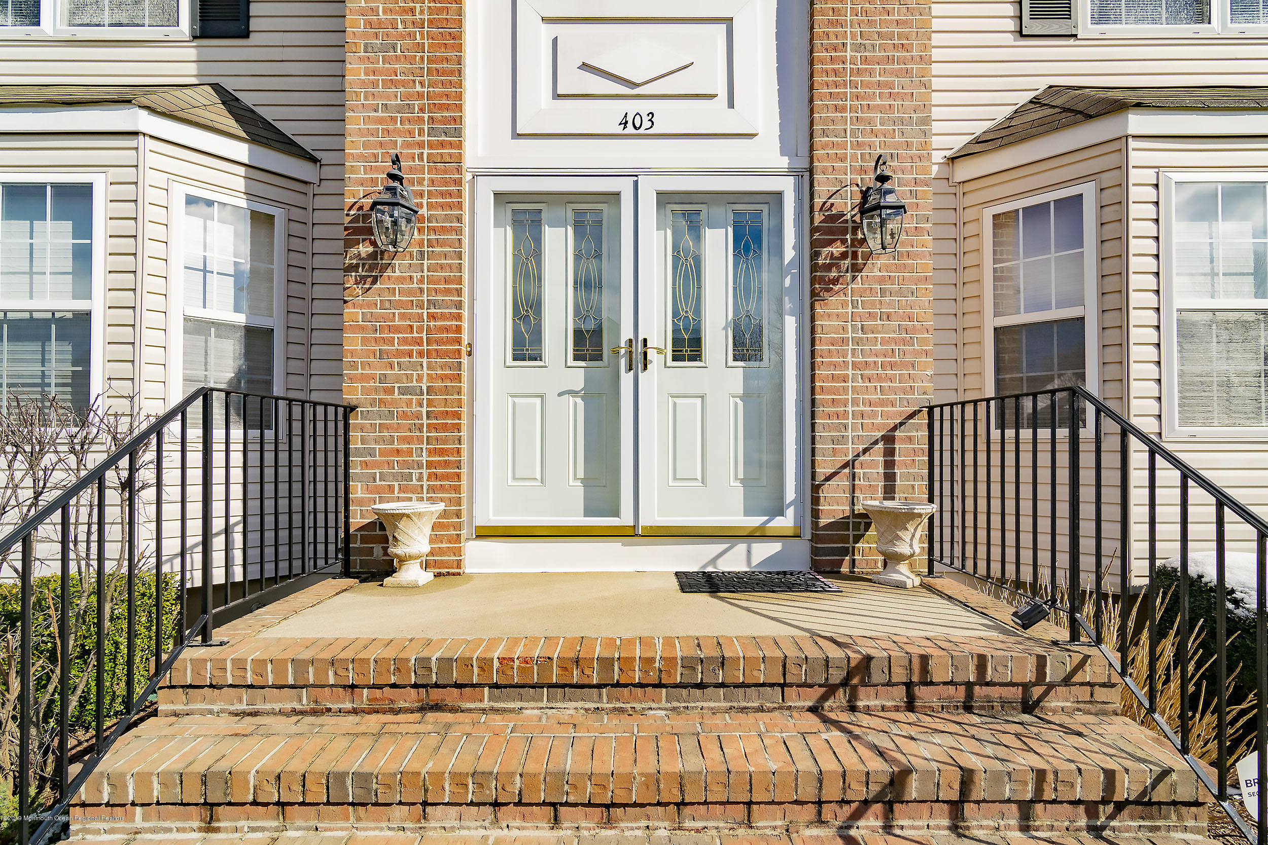 403 Meadowood Road Jackson, NJ 08527 - Photo 3 of 46 a view of a brick house with many windows
