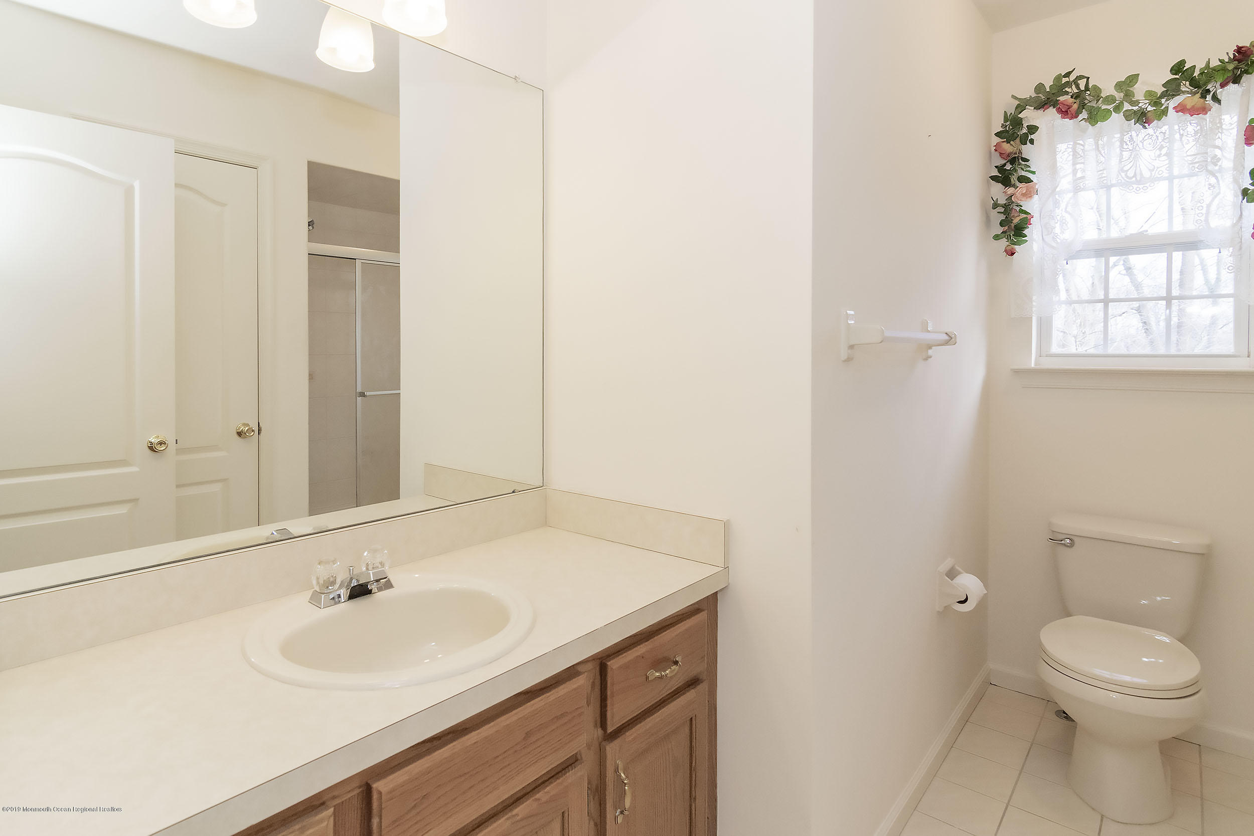 403 Meadowood Road Jackson, NJ 08527 - Photo 23 of 46 a bathroom with a sink toilet and window