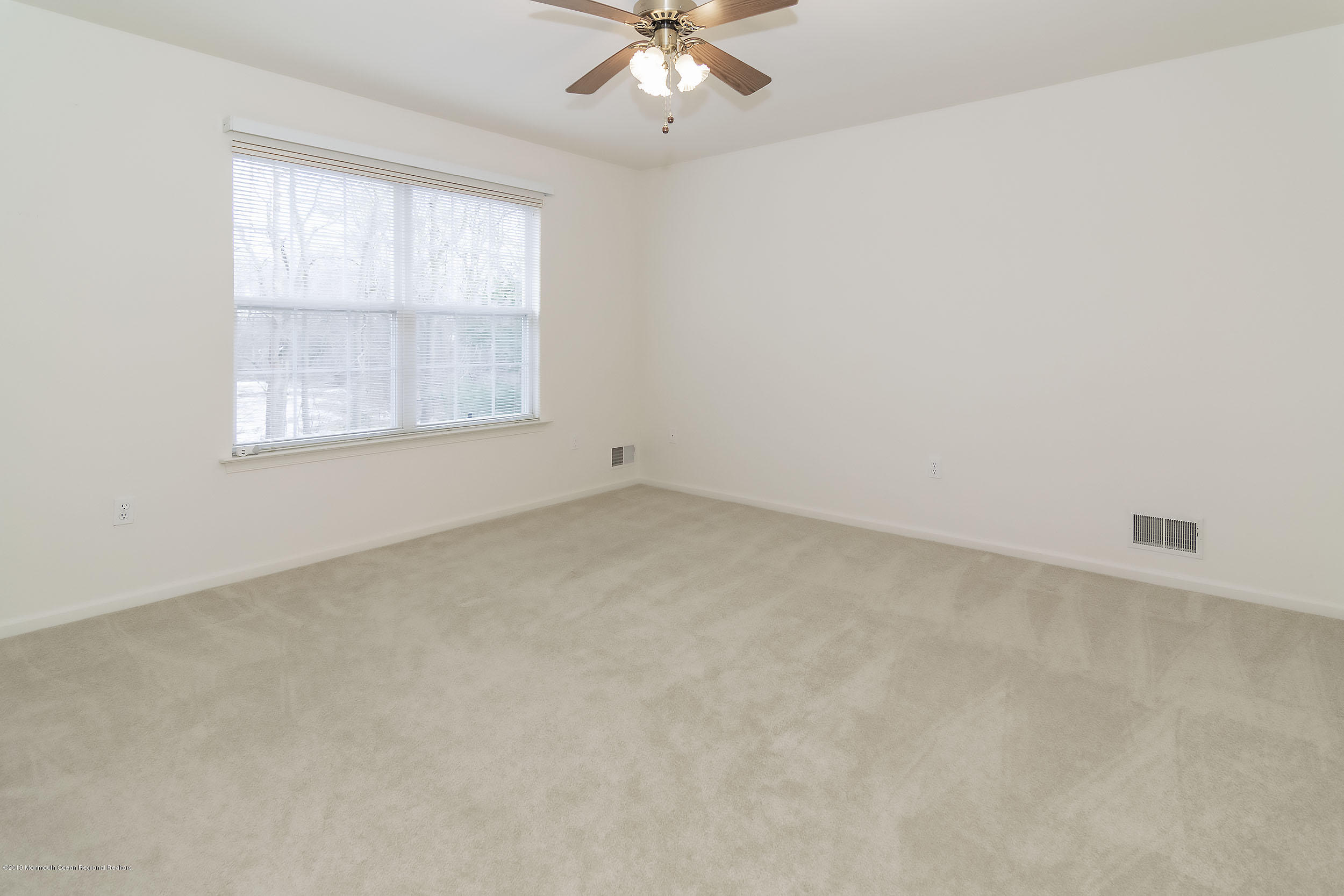 403 Meadowood Road Jackson, NJ 08527 - Photo 25 of 46 an empty room with a window