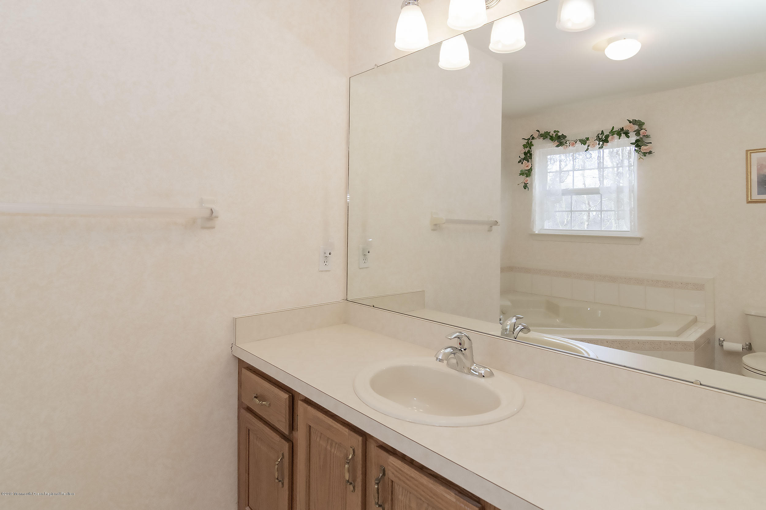 403 Meadowood Road Jackson, NJ 08527 - Photo 27 of 46 a bathroom with a sink and a mirror
