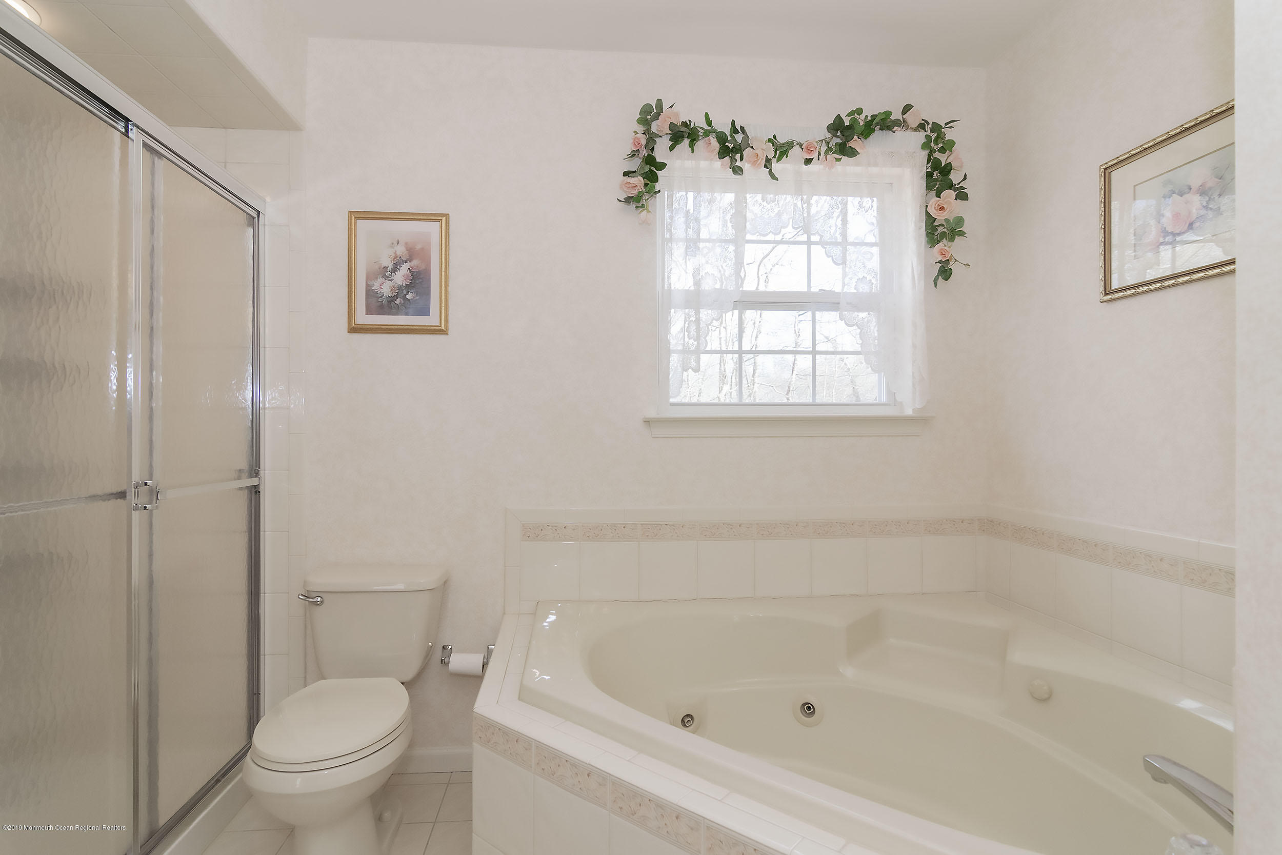 403 Meadowood Road Jackson, NJ 08527 - Photo 28 of 46 a white bath tub sitting next to a toilet