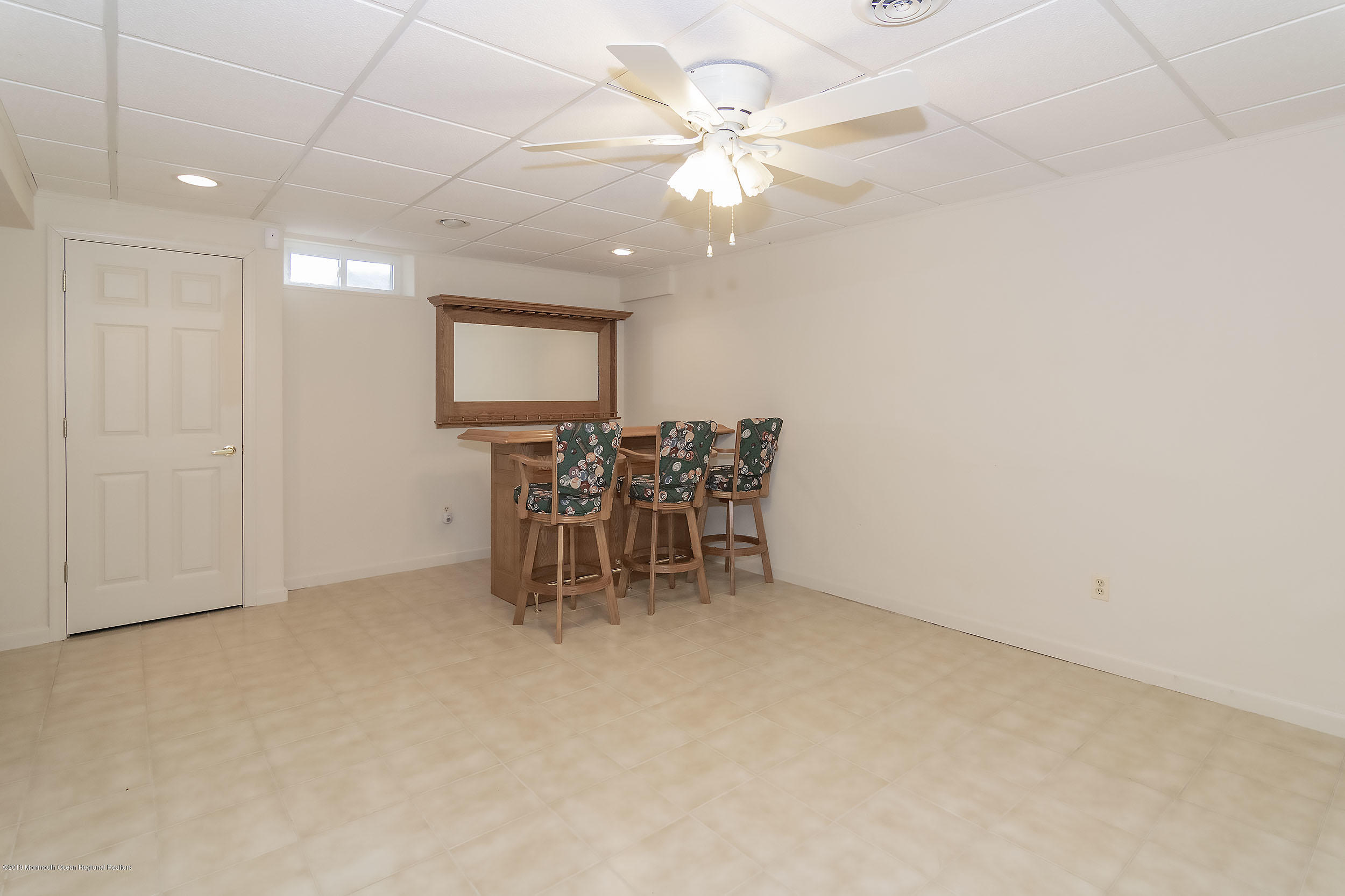 403 Meadowood Road Jackson, NJ 08527 - Photo 31 of 46 an empty room with chandelier fan and wooden floor
