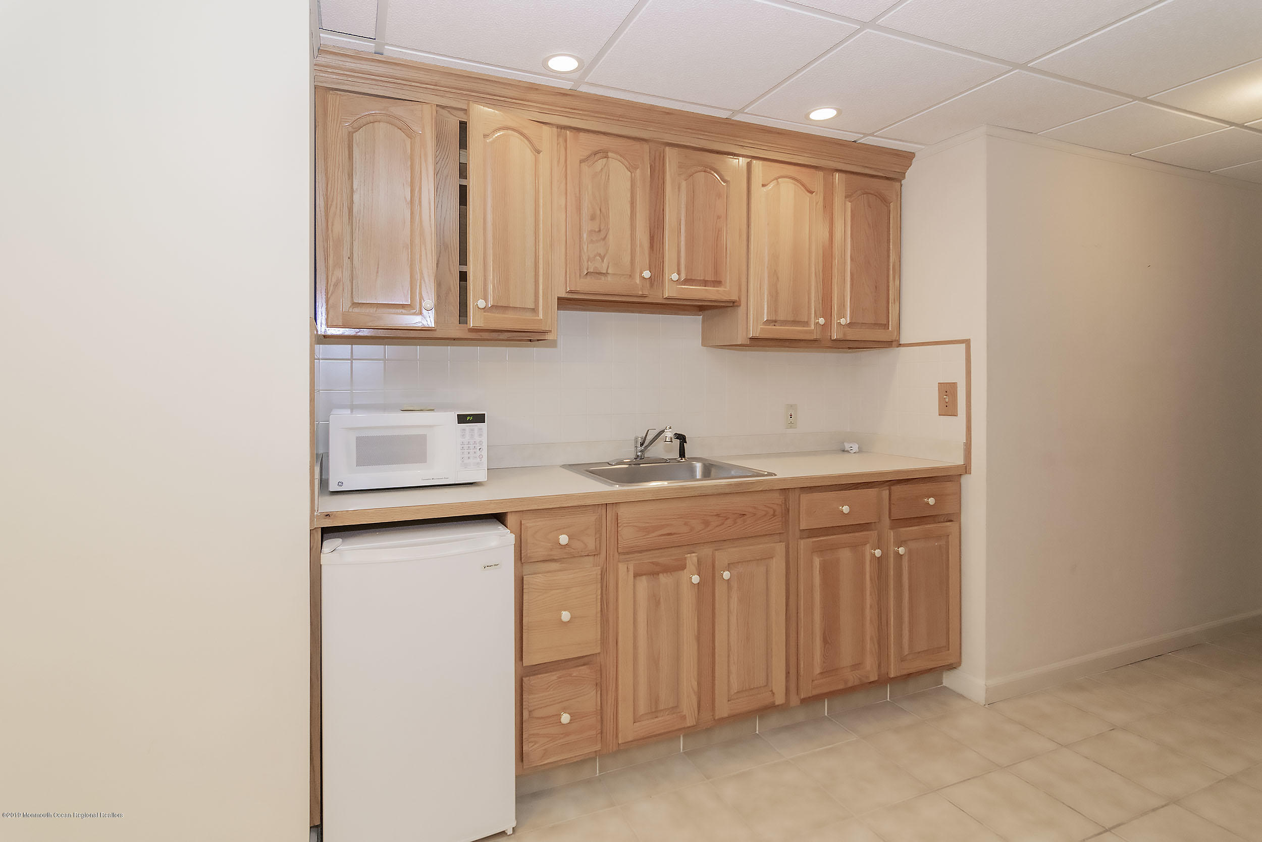 403 Meadowood Road Jackson, NJ 08527 - Photo 34 of 46 a kitchen with stainless steel appliances granite countertop a sink and dishwasher with white cabinets