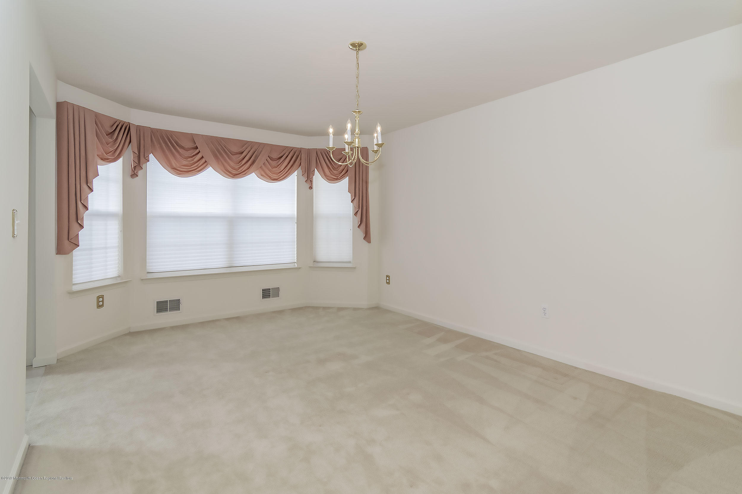 403 Meadowood Road Jackson, NJ 08527 - Photo 5 of 46 a view of an empty room with a window