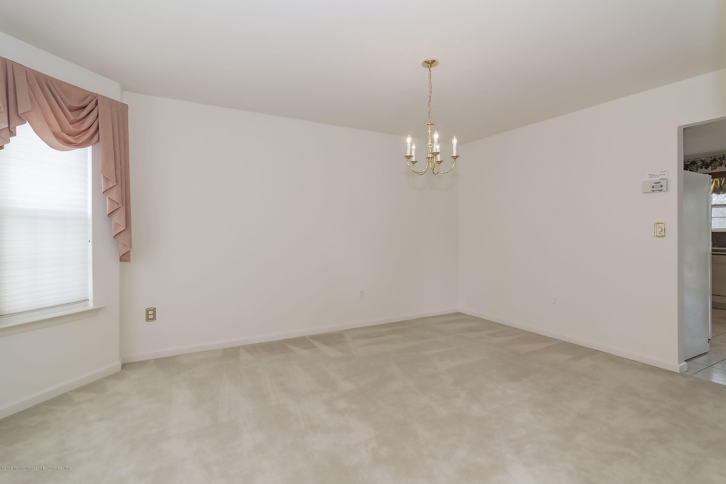 403 Meadowood Road Jackson, NJ 08527 - Photo 6 of 46 an empty room with chandelier fan