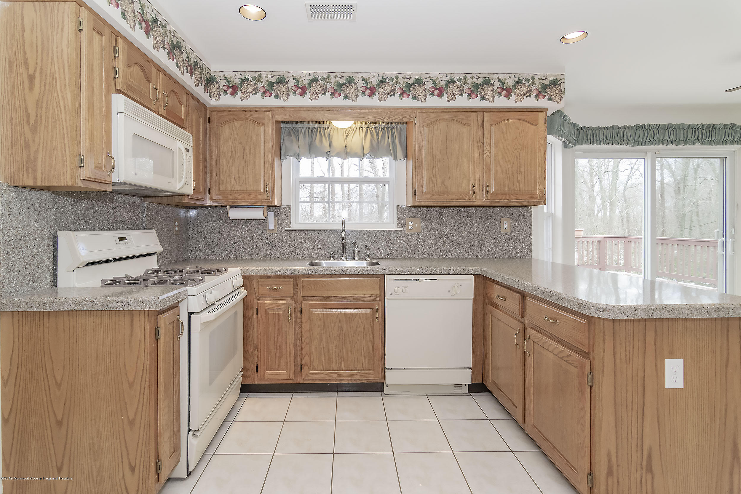 403 Meadowood Road Jackson, NJ 08527 - Photo 8 of 46 a kitchen with a sink stove and cabinets