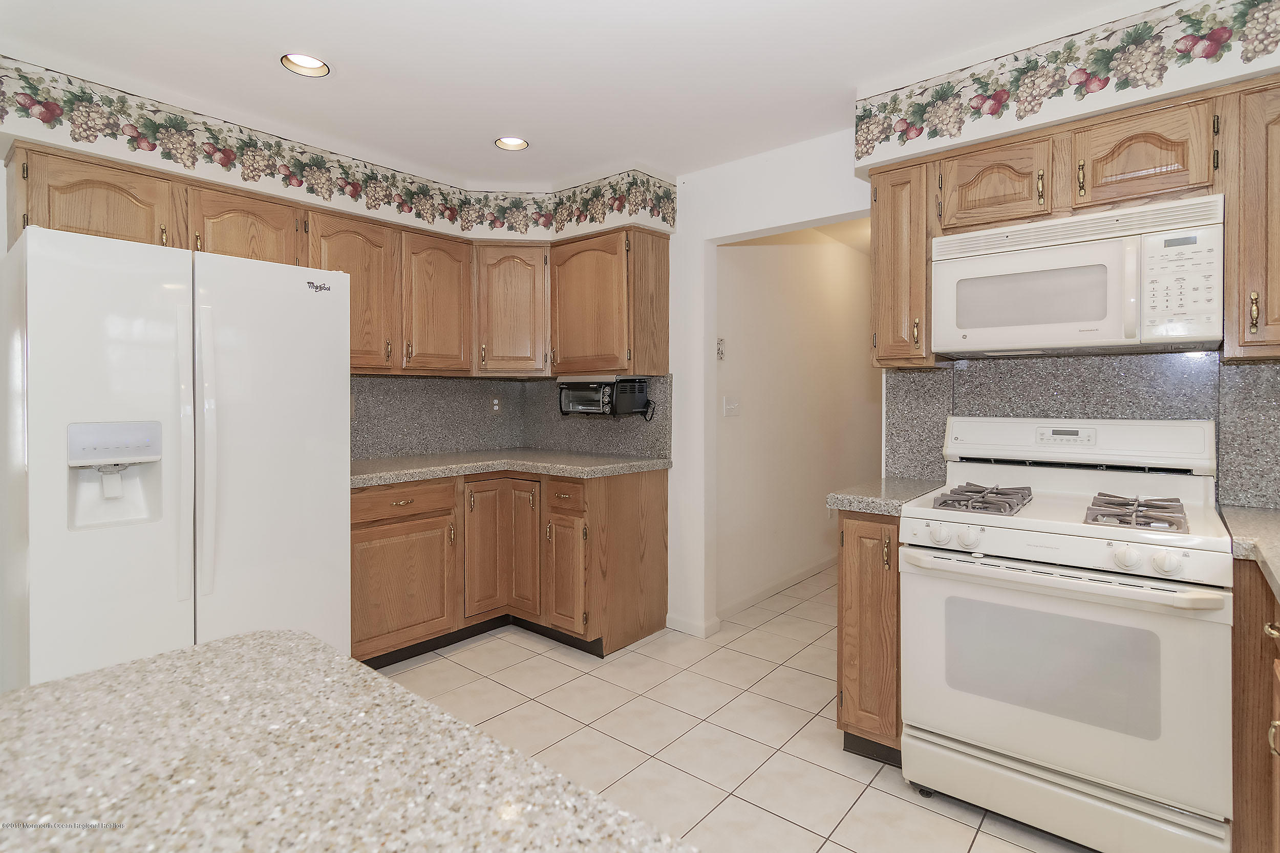 403 Meadowood Road Jackson, NJ 08527 - Photo 10 of 46 a kitchen with a stove a sink and a refrigerator