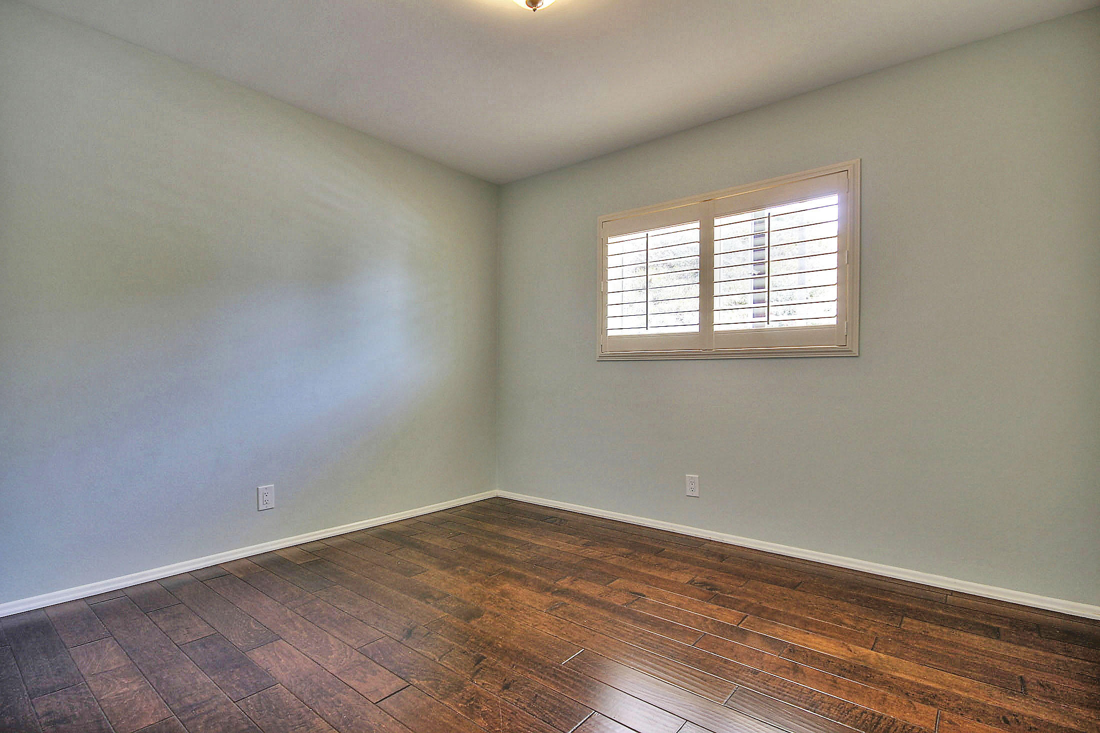 515 Fellowship Road Santa Barbara, CA 93109 - Photo 14 of 25 an empty room with wooden floor and windows