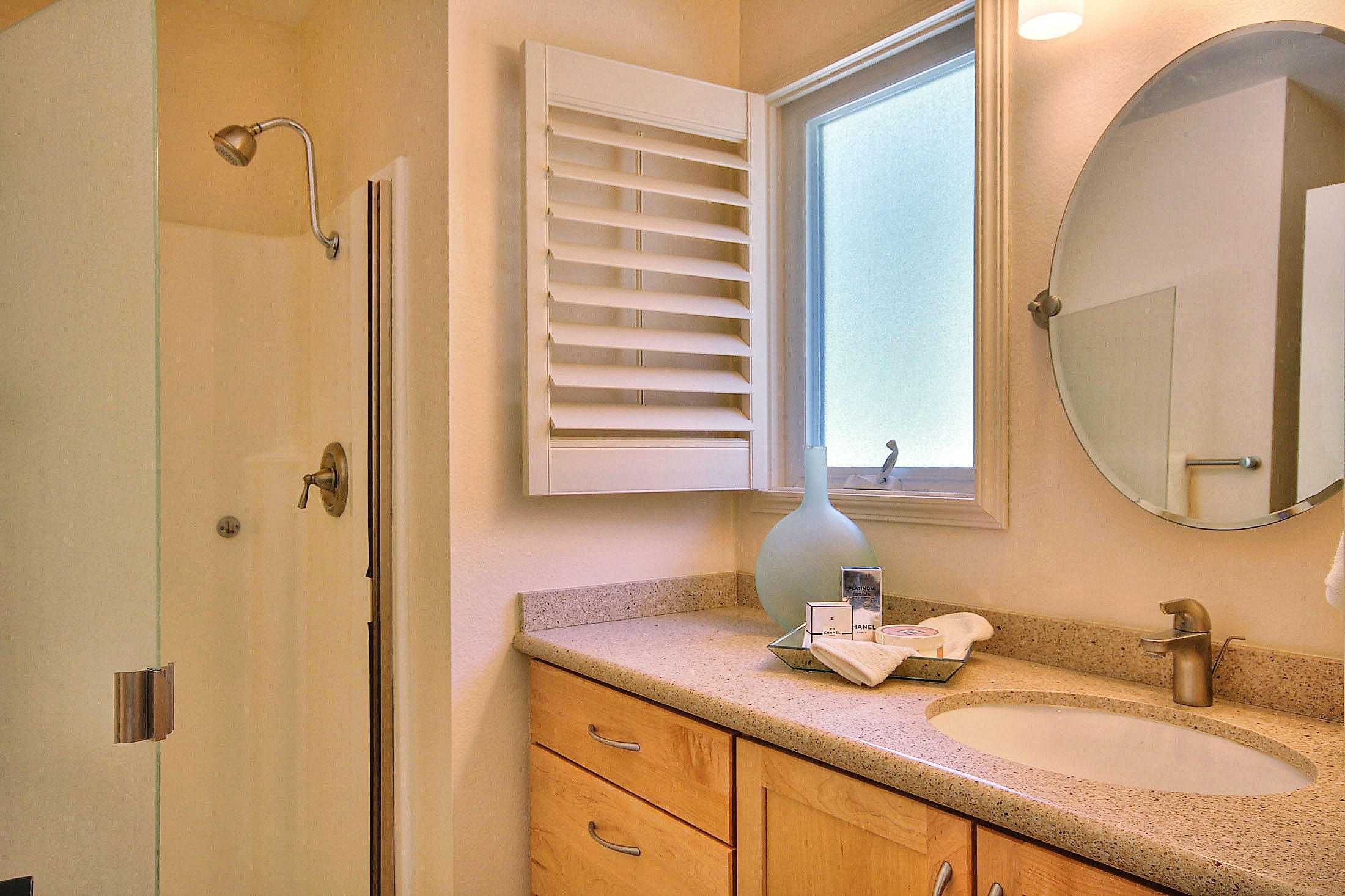 515 Fellowship Road Santa Barbara, CA 93109 - Photo 18 of 25 a bathroom with a granite countertop sink and a mirror