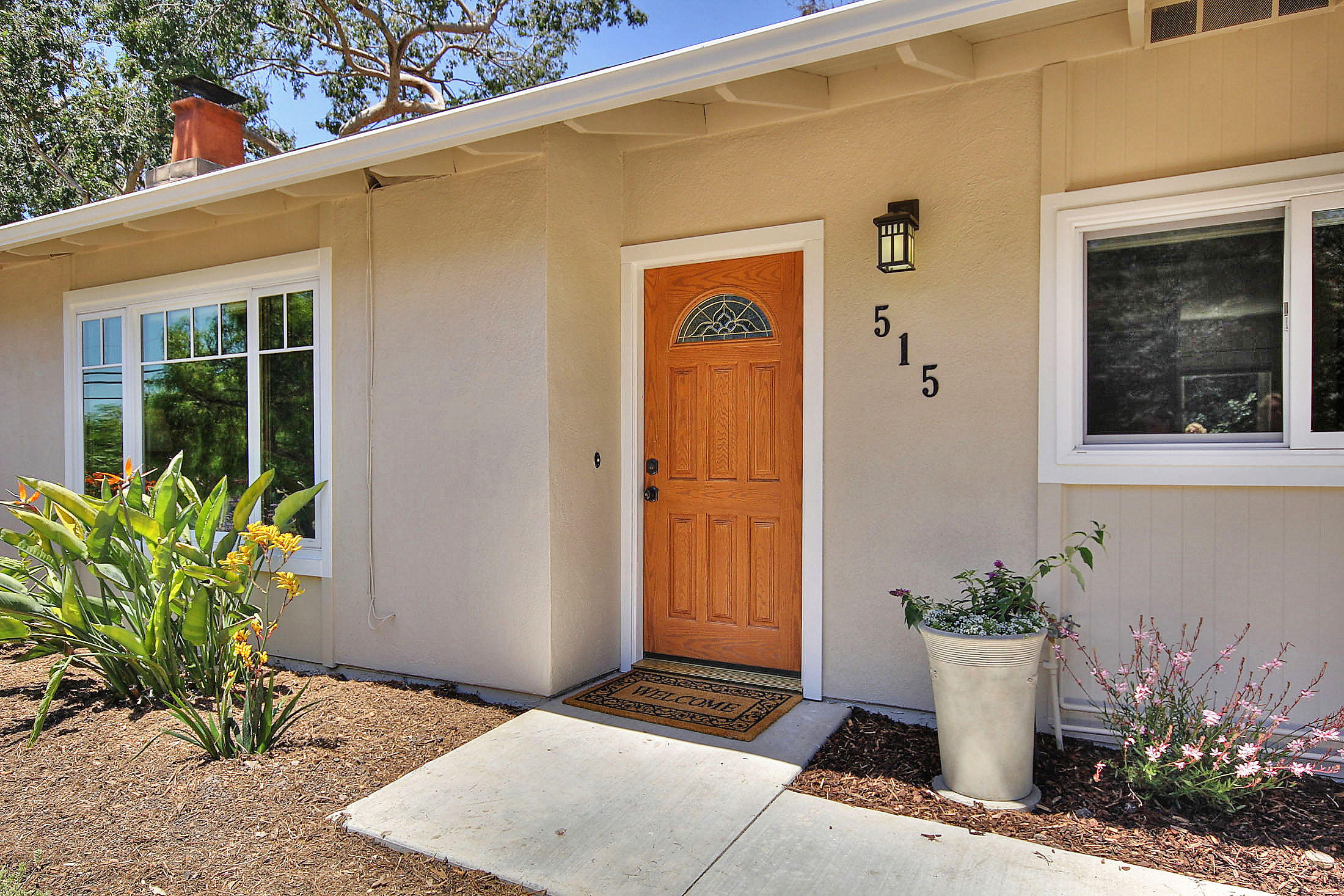 515 Fellowship Road Santa Barbara, CA 93109 - Photo 3 of 25 a front view of a house with potted plants