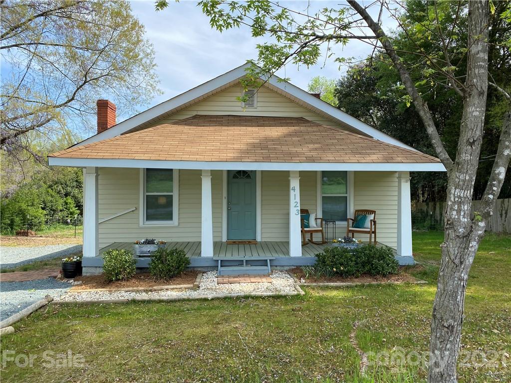 a front view of a house with a yard and porch
