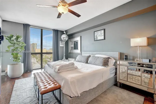 a bedroom with a bed and a potted plant