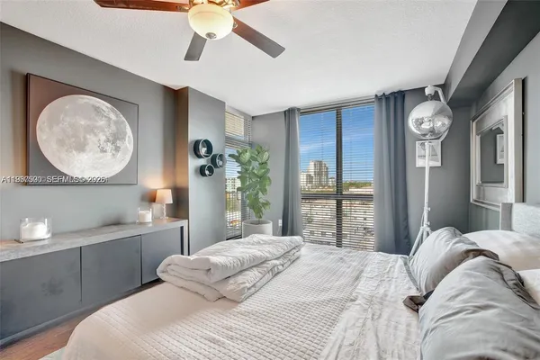 a bedroom with a large bed and a chandelier