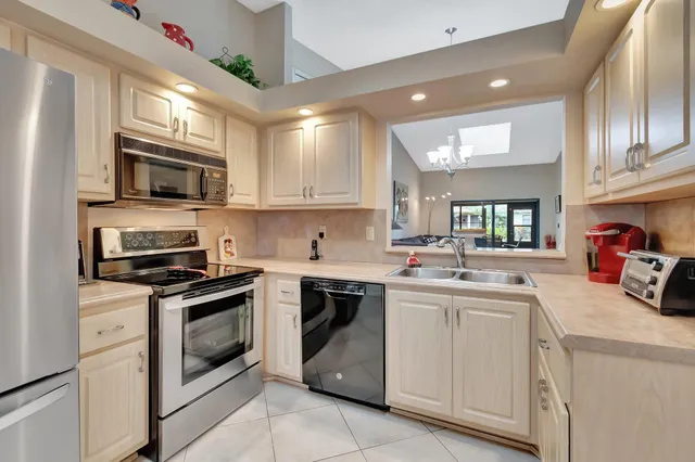 a view of a dining room with furniture and a potted plant