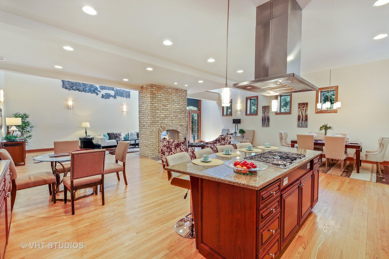 697 Rienzi Lane Highwood, IL 60040 - Photo 3 of 24 a open kitchen with stainless steel appliances granite countertop a stove top oven a dining table and chairs with wooden floor
