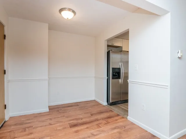 a view of a livingroom with wooden floor and closet