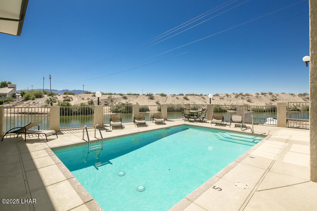 94 London Bridge Road, Unit 108 Lake Havasu City, AZ 86403 - Photo 38 of 38 a view of a swimming pool with a lounge chair