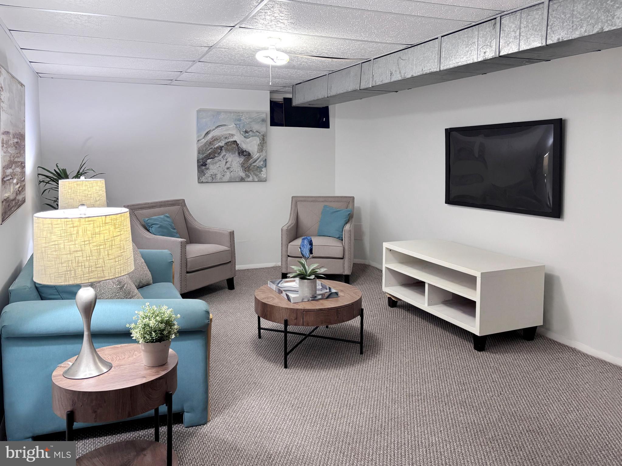 8 Beckett Court Ewing, NJ 08628 - Photo 12 of 20 a living room with furniture and a flat screen tv