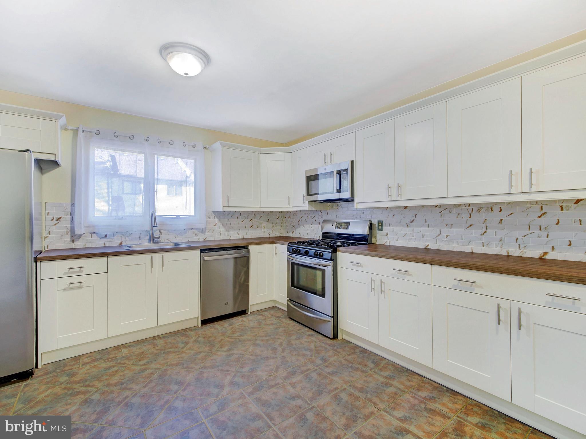 8 Beckett Court Ewing, NJ 08628 - Photo 5 of 20 a kitchen with granite countertop white cabinets white stainless steel appliances with a sink and dishwasher
