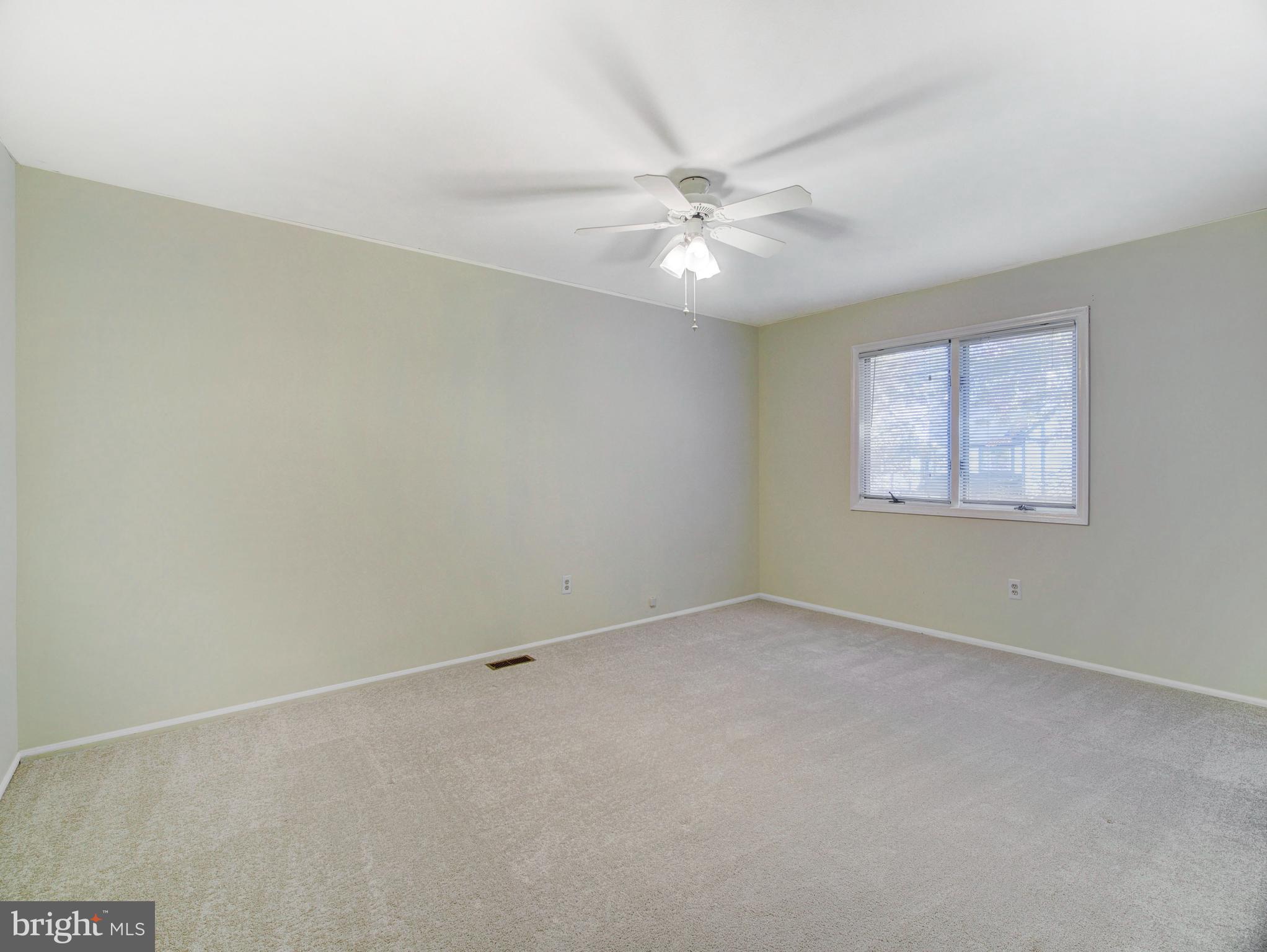 8 Beckett Court Ewing, NJ 08628 - Photo 9 of 20 an empty room with a window and a fan