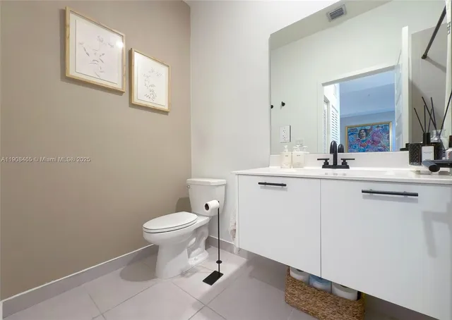 a bathroom with a sink toilet and a mirror