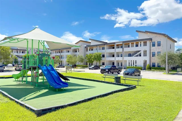 a view of a house with swimming pool and sitting area