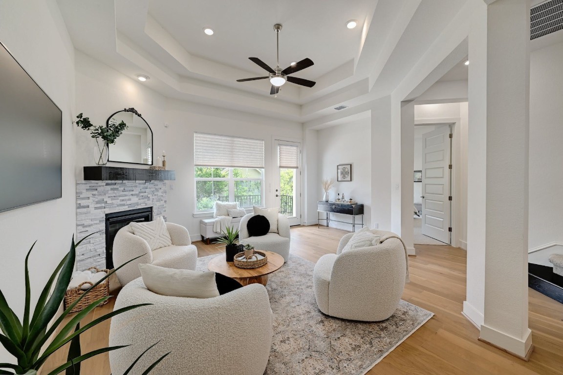 a living room with fireplace furniture and a large window