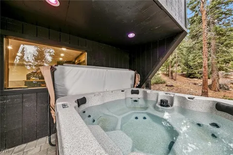a bathroom with a tub sink and mirror