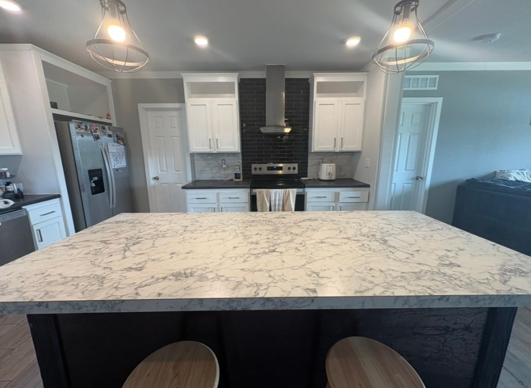2854 Benny Griffin Road Livingston, TX 77351 - Photo 8 of 19 a kitchen with kitchen island sink refrigerator and microwave