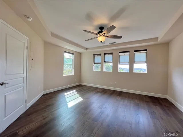 a view of an empty room window and wooden floor