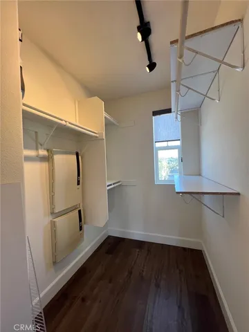 a view of a room with wooden floor and white walls