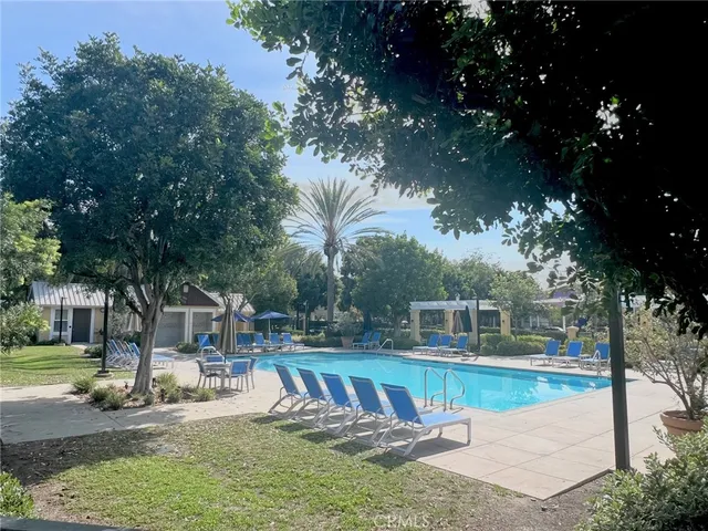 a view of a house with swimming pool and sitting area