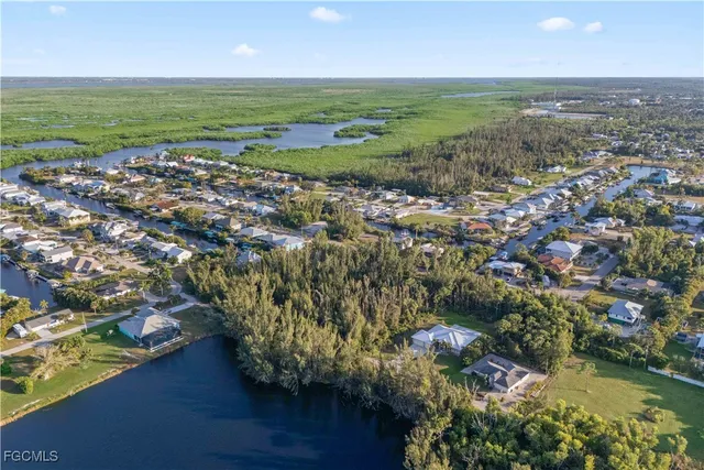an aerial view of ocean and residential houses with outdoor space and lake view