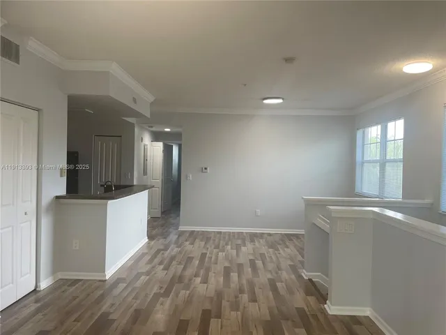 a view of a kitchen cabinets and wooden floor