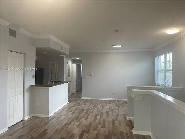a view of hallway with wooden floor