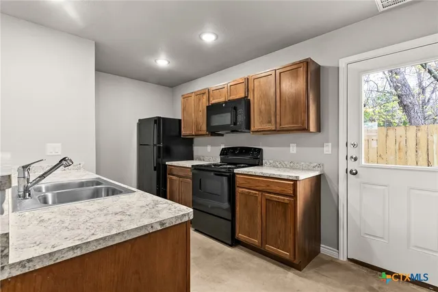 a kitchen with a sink stove and refrigerator