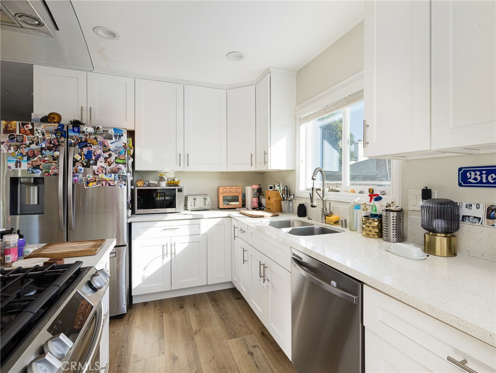 526 Sheldon Street El Segundo, CA 90245 - Photo 11 of 41 a kitchen with a sink a stove and cabinets
