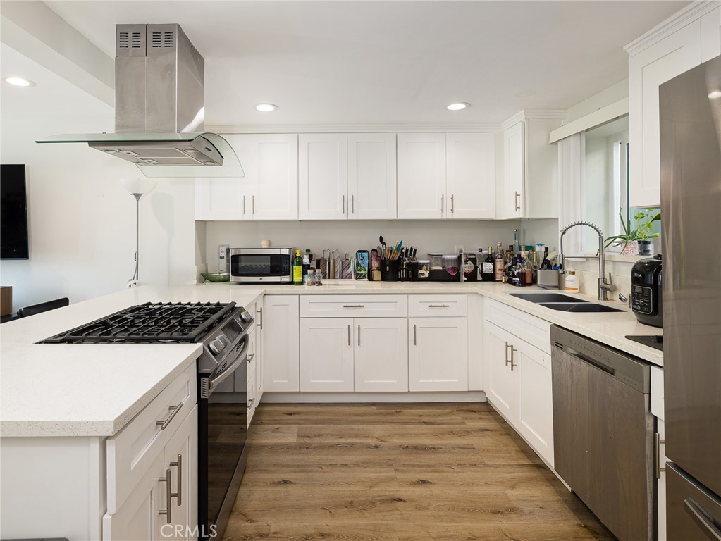 526 Sheldon Street El Segundo, CA 90245 - Photo 25 of 41 a kitchen with cabinets appliances a sink and a counter top space
