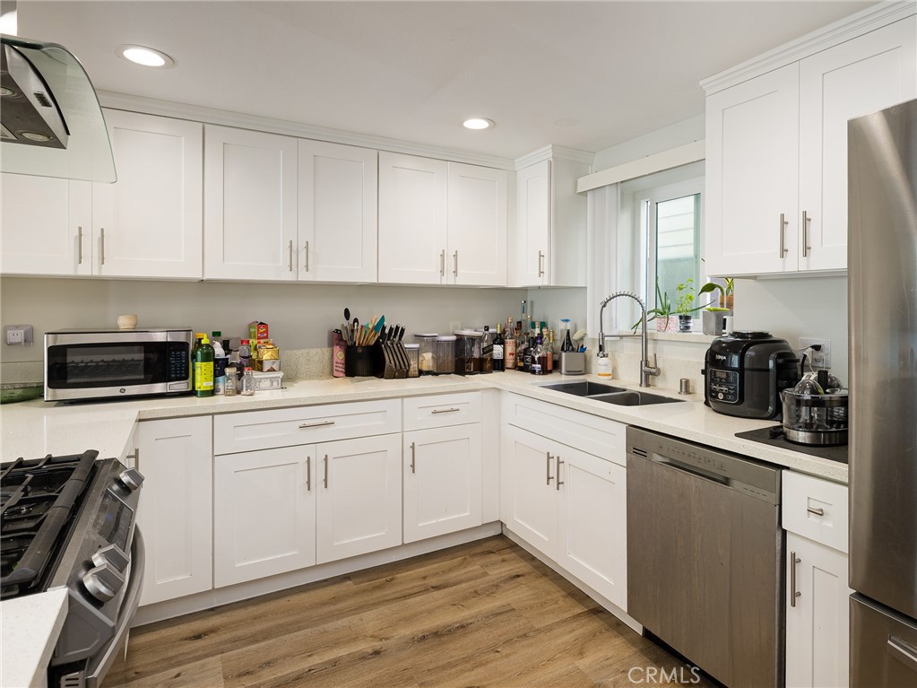526 Sheldon Street El Segundo, CA 90245 - Photo 26 of 41 a kitchen with cabinets appliances a sink and a counter top space