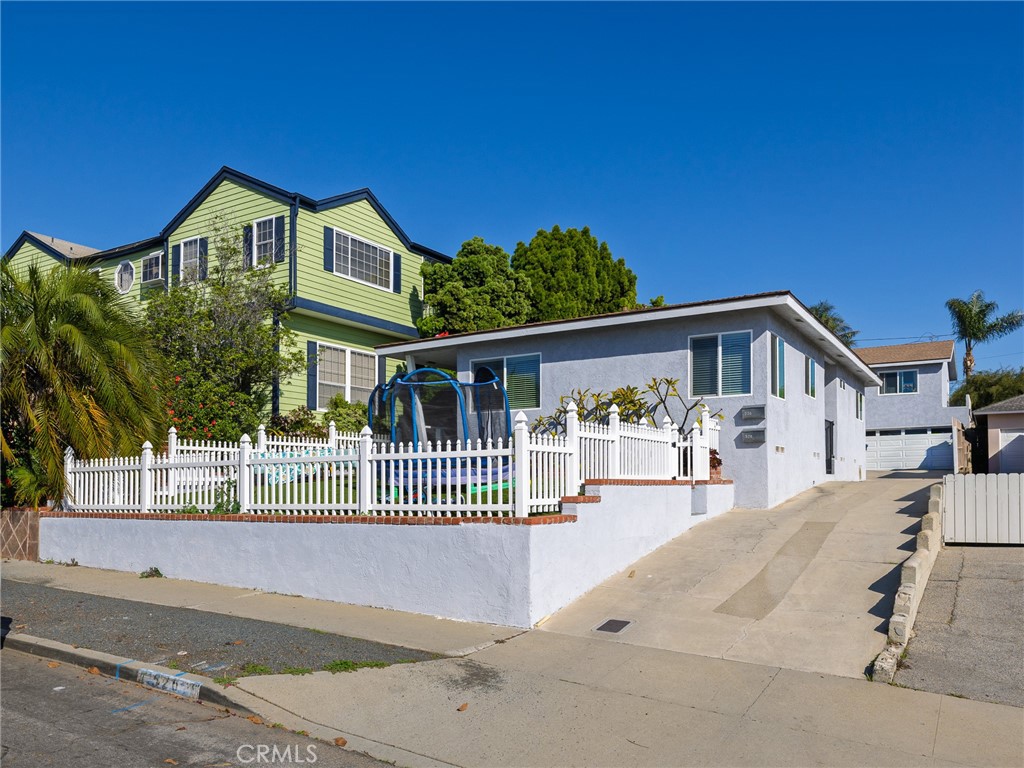 526 Sheldon Street El Segundo, CA 90245 - Photo 3 of 41 a view of a house with a small yard and wooden fence